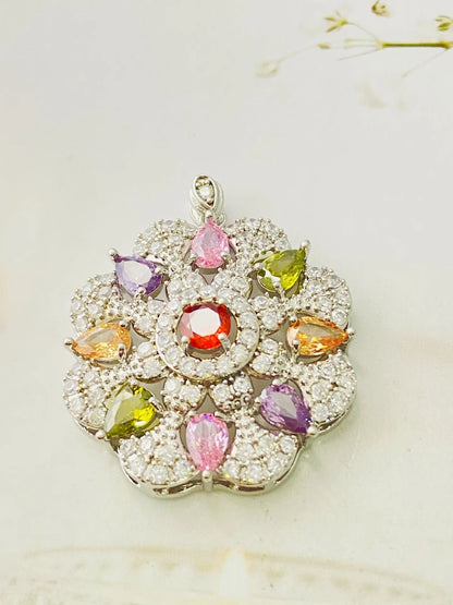 Close-up of a women's gold-coloured flower pendant necklace with a bright zircon stone centre.
