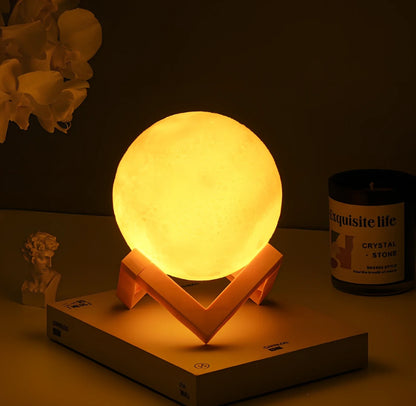 3D printed moon night light with detailed lunar surface and dual-colour LED lighting on beech wood stand
