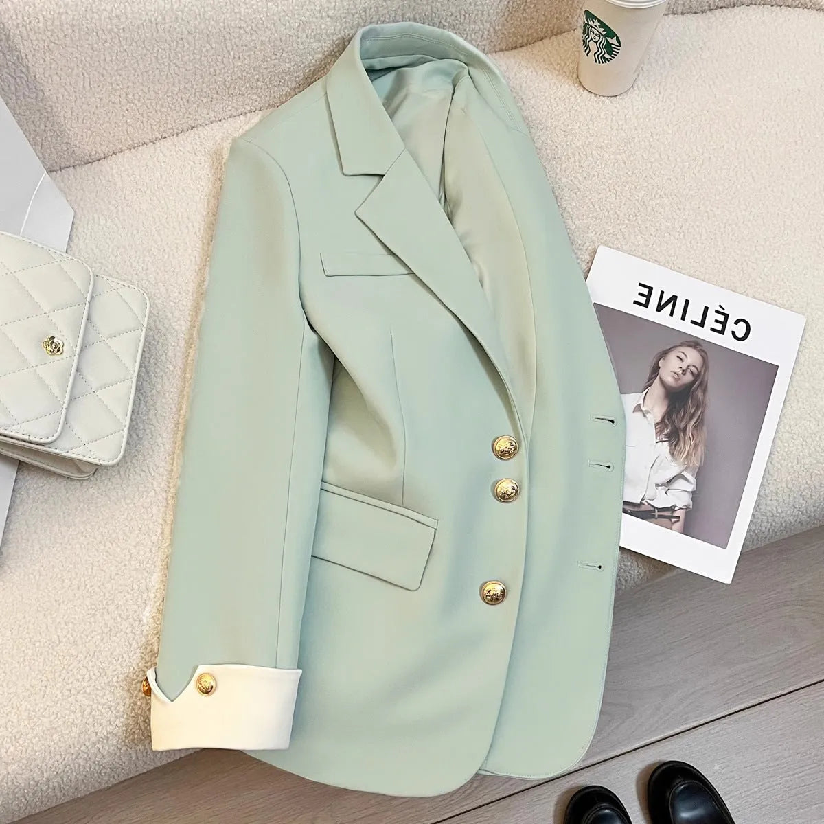 Milky white loose fit Korean-style women's coat with long sleeves and pockets.
