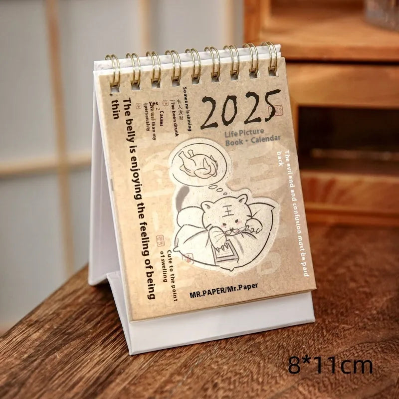 2025 mini desk calendar showing one of four designs: Coffee Time, Awake Time, Corner Perching, or Afternoon Lazy.