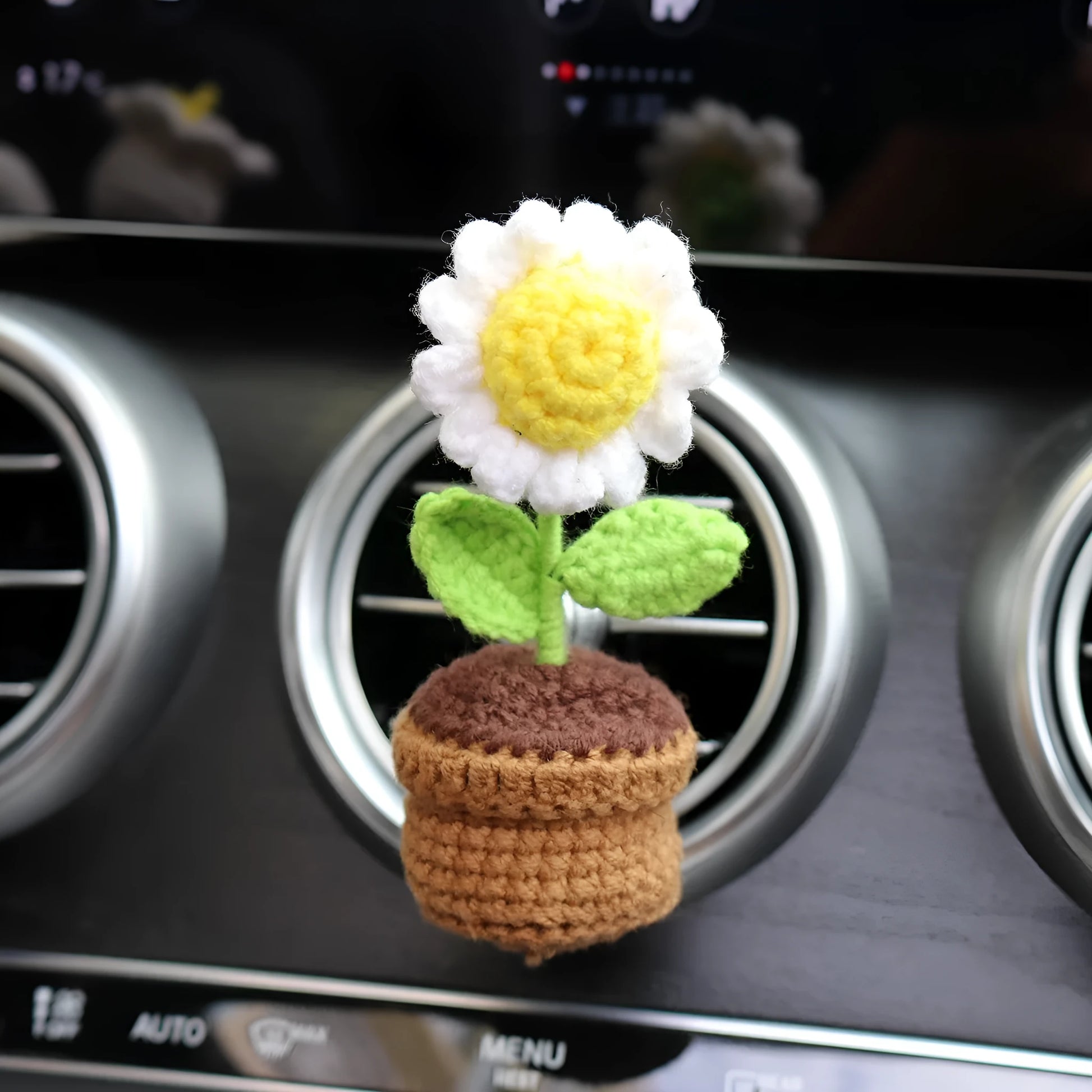Creative wool potted plant car air vent clip aromatherapy pendant on a car vent.