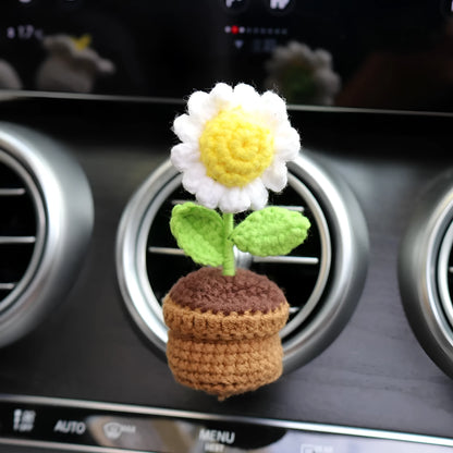 Creative wool potted plant car air vent clip aromatherapy pendant on a car vent.