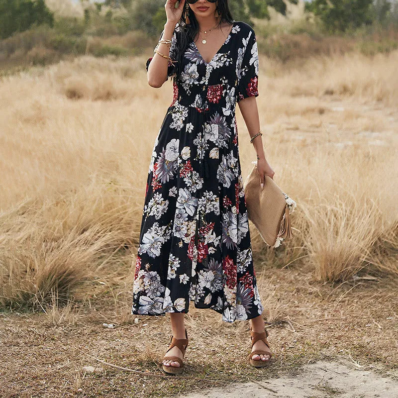 Yellow floral print women's dress with V-neck, short sleeves, elastic waist, and a large hemline midi skirt.