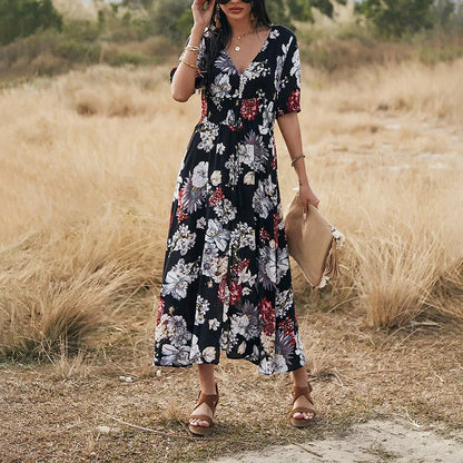 Yellow floral print women's dress with V-neck, short sleeves, elastic waist, and a large hemline midi skirt.