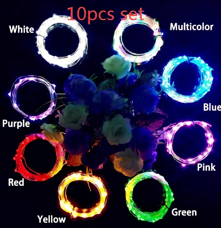 Copper wire LED string lights wrapped around wine bottle with 20 white LEDs illuminated