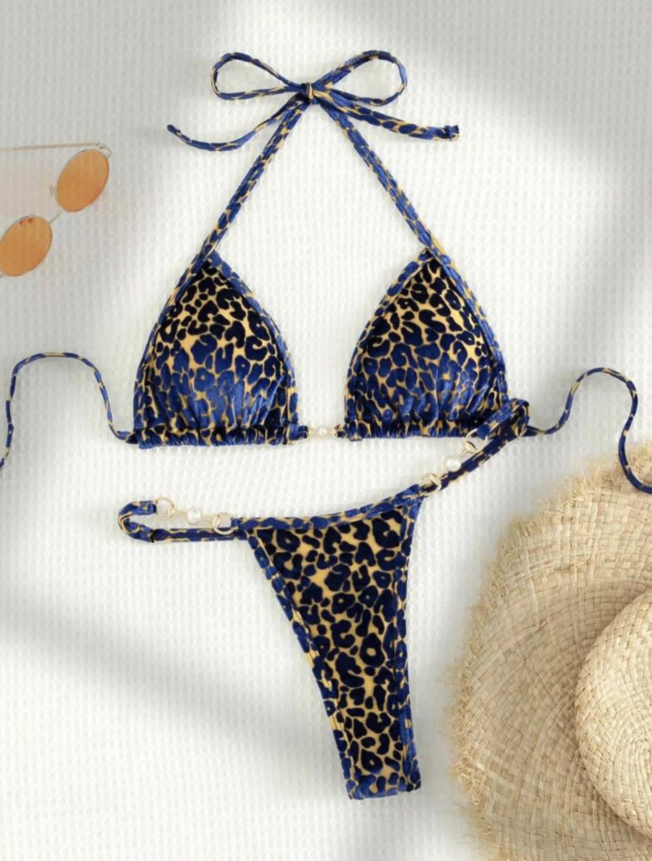 Women's blue leopard print T-shaped bikini set for swimming on a mannequin.