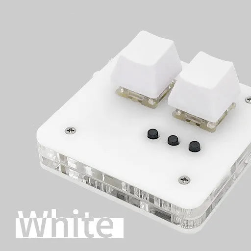 Mini white plastic USB wired keyboard with multimedia keys on a desk.