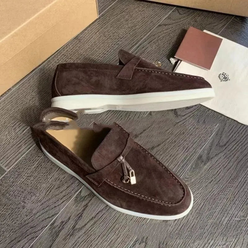 High top slip-on loafers in black with round toe and sewing line detail on a rubber sole.