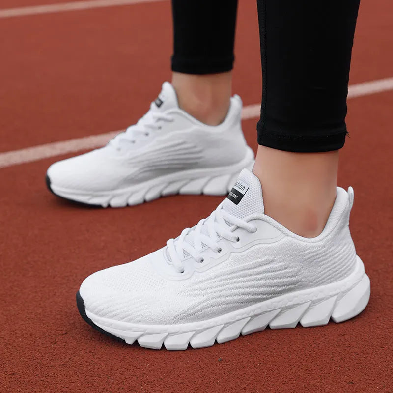 Women's black and white low-top running casual sneakers with MD sole and cross strap detail