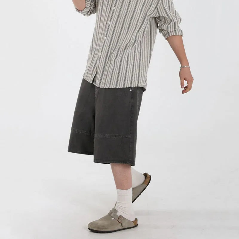 Men's grey loose fit denim shorts with mid waist and zip fly, cropped length, sizes M to 2XL