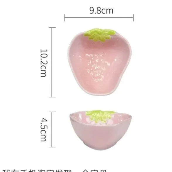 Porcelain dinnerware set with strawberry pattern, showing plates, bowls, and a twist spoon in various sizes