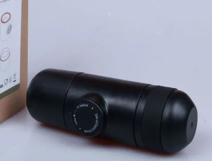 Black portable manual coffee machine with pressure gauge, 6cm wide and 17.5cm tall.