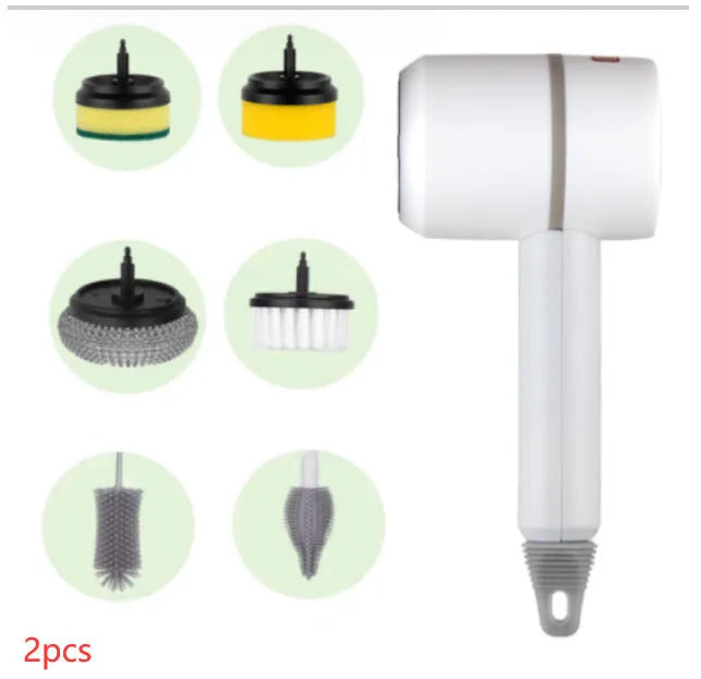 Green electric cleaning brush with scouring pad and brush heads on a kitchen worktop.