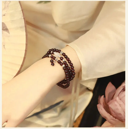 Handmade antique Chinese style bracelet with red imitation garnet and pomegranate design in a gift box.