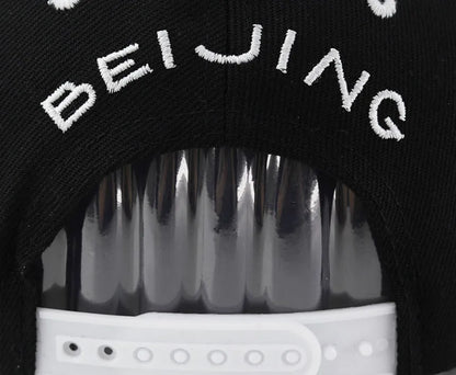 Cotton baseball hat with letter embroidery showing dome crown and adjustable strap in black and white colour options