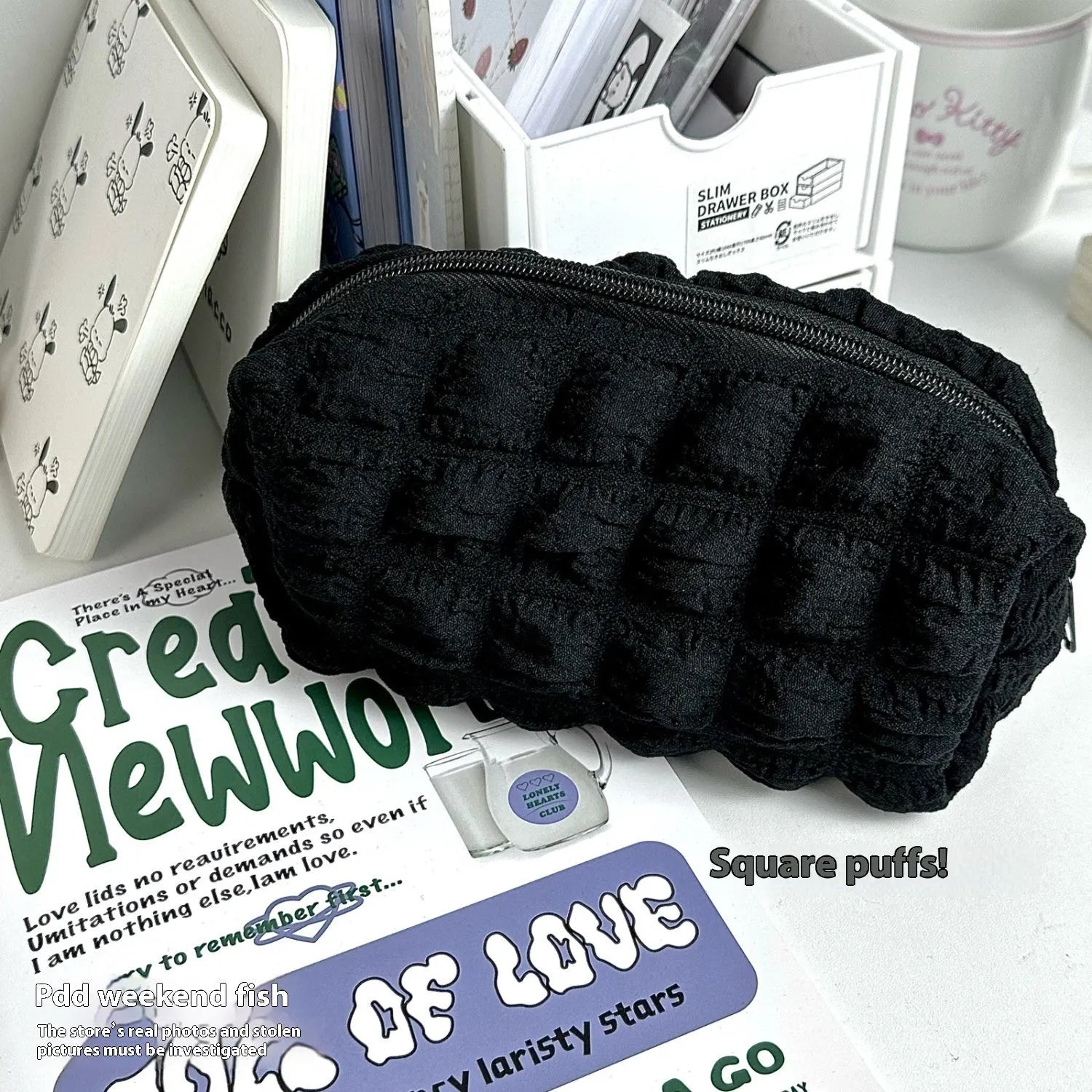Beige and black fabric pencil case with padded cream puff design measuring 20cm length
