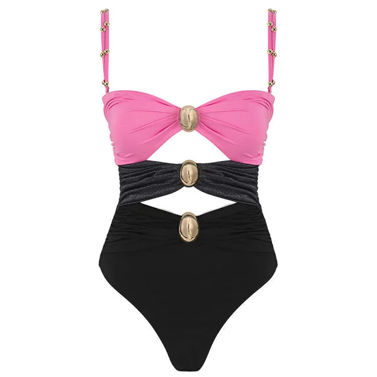 Women's green one-piece swimsuit with round buckle decoration and hollow-out stitching detail on nylon fabric.