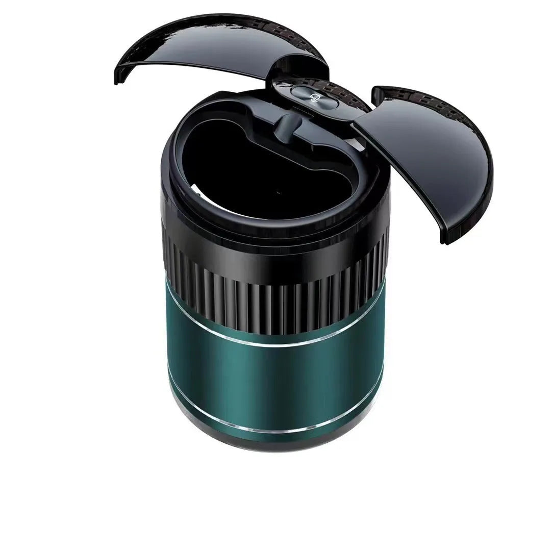 Compact black metal car ashtray with automatic lid on a car console