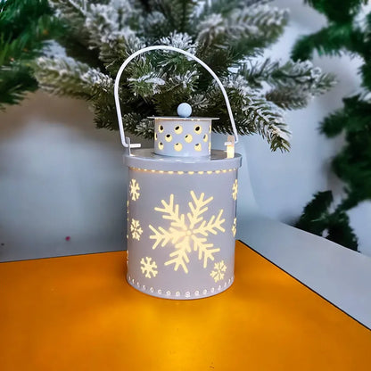 Green wrought iron electronic candle lantern with flickering LED light on a wooden mantel.