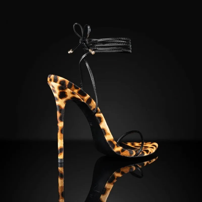 Women's leopard print pointed toe Roman sandals with a lace-up front and buckle.