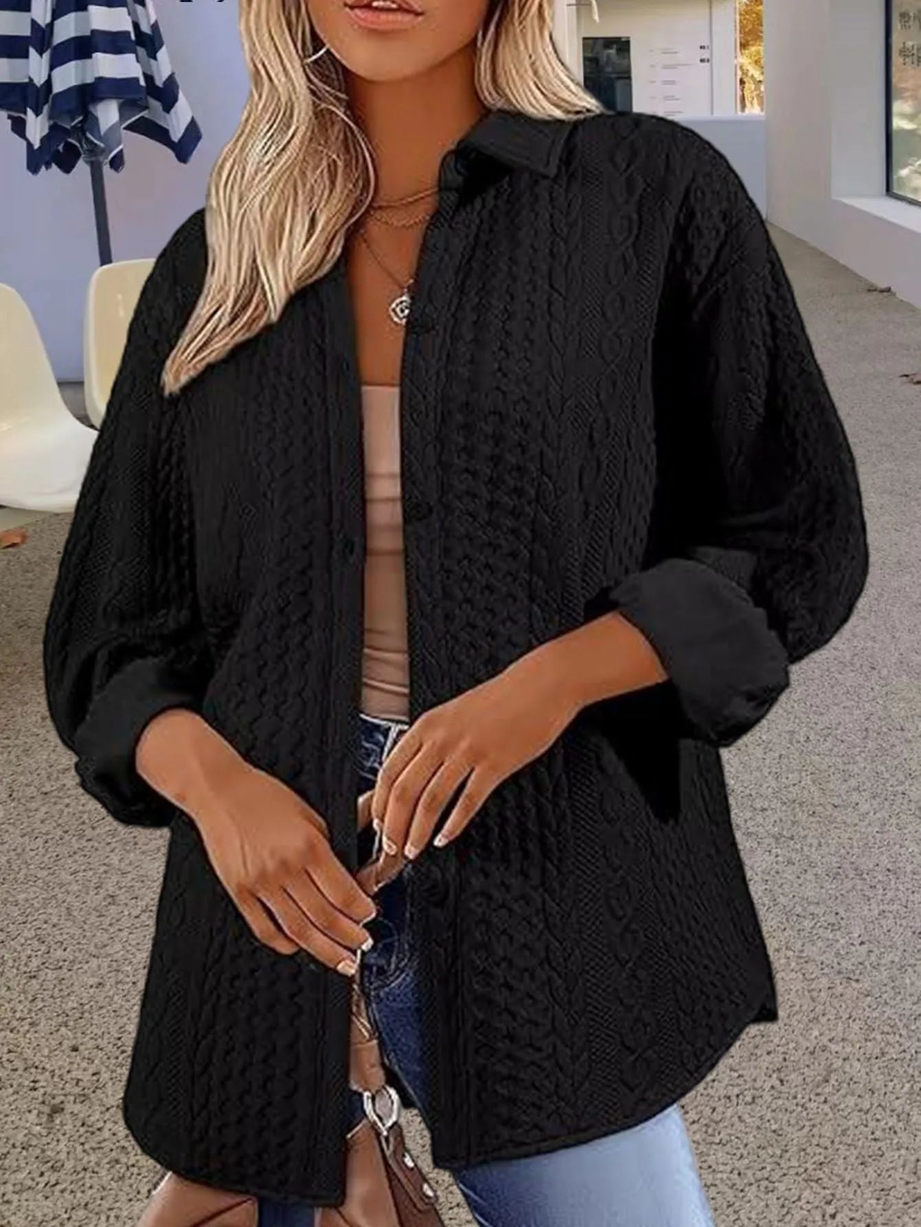 Women's solid colour cardigan sweater in black, shown open as a long-sleeved layer.