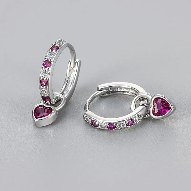 Fashion zircon earrings with 10mm heart-shaped drops in gold and white gold settings, showing diamond-treated stones