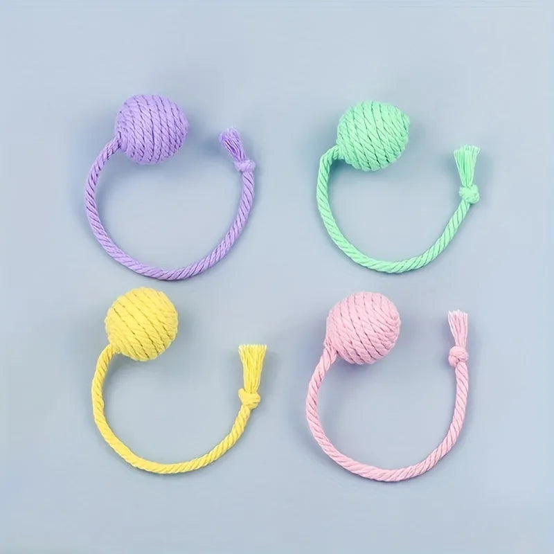 Interactive cat toy ball with bell and rope in green, pink, purple or yellow colours, shown in 3cm and 6cm sizes