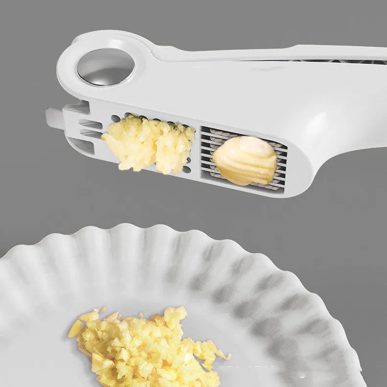 White manual garlic press with stainless steel mechanism on wooden kitchen surface