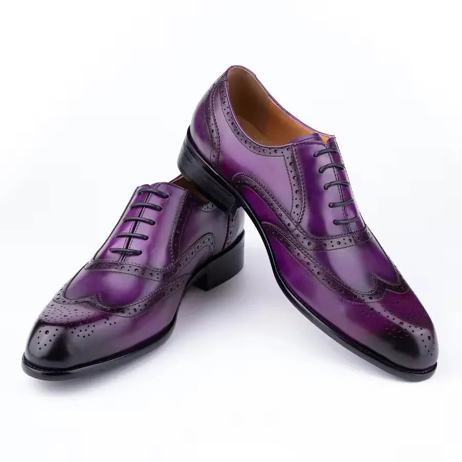 Men's purple leather Oxford shoes with hand-carved design and pointed toe on a rubber sole.