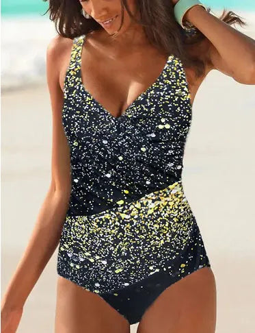 Purple and green striped one-piece swimsuit for women on a hanger
