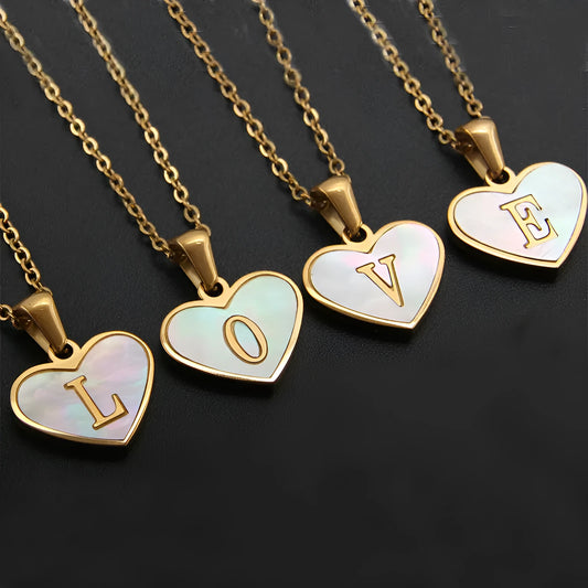 Gold-plated clavicle necklace with a white shell heart pendant, personalised with a letter from A to Z.