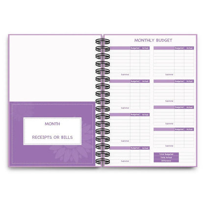 Purple A5 financial planning notebook with coil binding, showing monthly budget layout and included pen with stickers