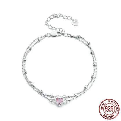 Close-up of a sweet girlish style 925 sterling silver bracelet with a small heart-shaped pendant on an adjustable chain.