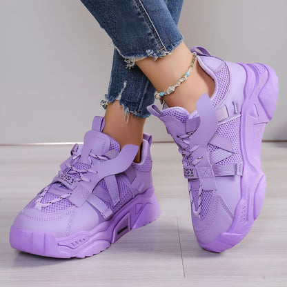 Women's platform sneakers in animal print with breathable mesh upper and front lace-up design.
