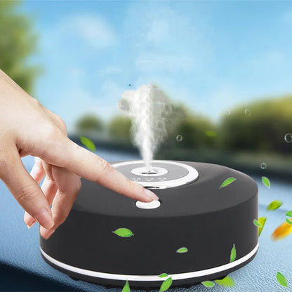 Black plastic USB-powered vehicle mounted aromatherapy machine with anti-slip pad on a car dashboard.