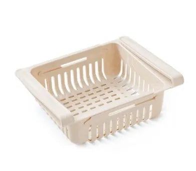 Plastic telescopic refrigerator storage basket in apricot colour, showing multiple compartments for organisation.