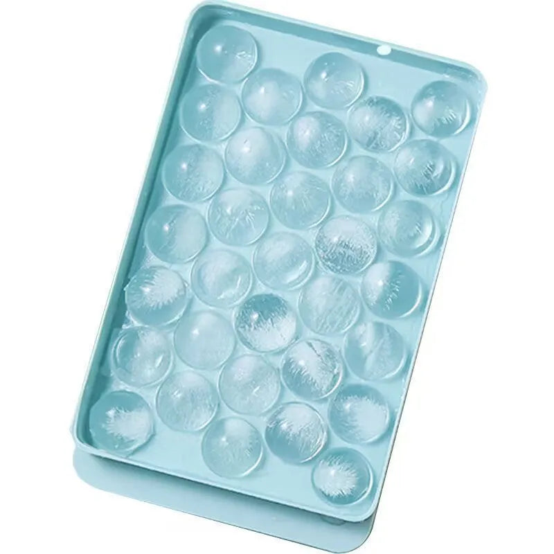 Blue silicone ice cube tray with lid showing 33 round cavities, measuring 24x14cm