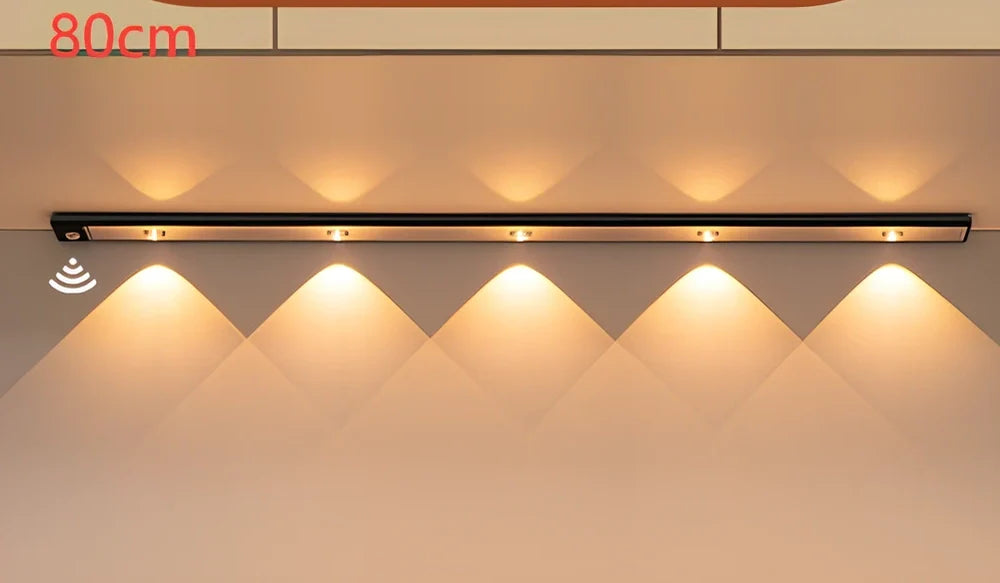 Silver LED inductive light strip, 40cm length, attached to shoe cabinet shelf with 3M adhesive