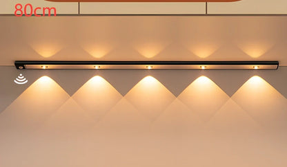 Silver LED inductive light strip, 40cm length, attached to shoe cabinet shelf with 3M adhesive