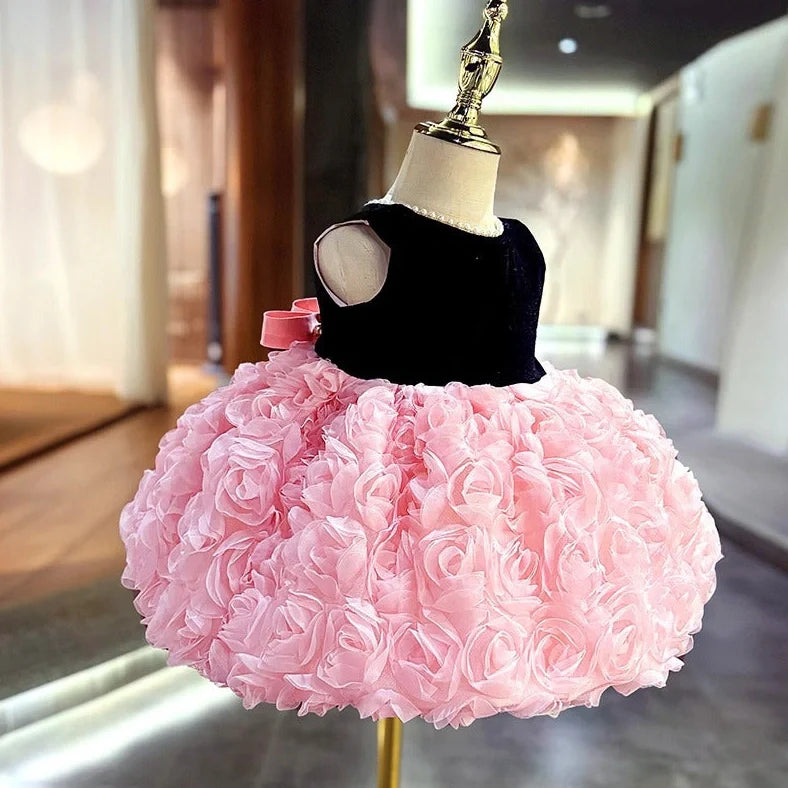 Pink girls summer dress with colour-matched design on hanger, showing polyester fabric texture