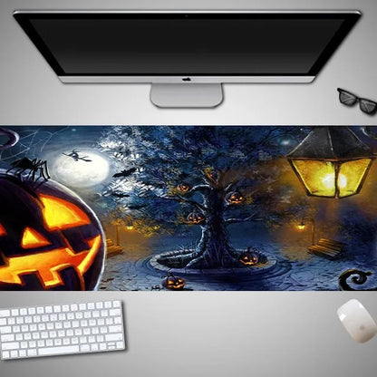Oversized black Halloween-themed mouse pad with graphic design on a wooden desk, showing non-slip rubber base.