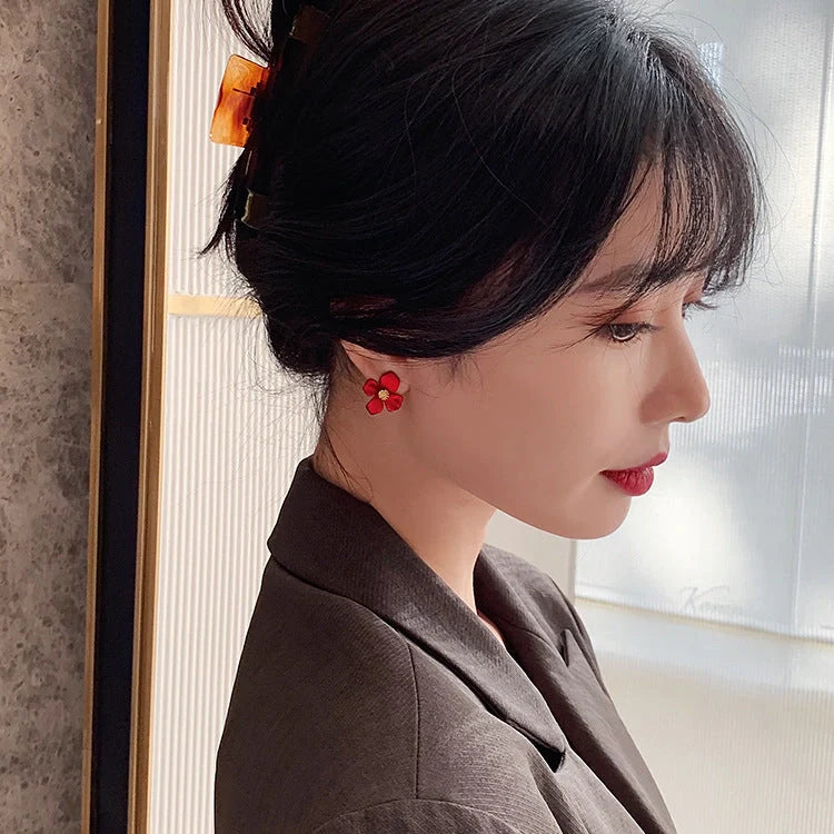 Silver-tone earrings with delicate red petal design, perfect for adding a touch of Korean-inspired elegance to any outfit.