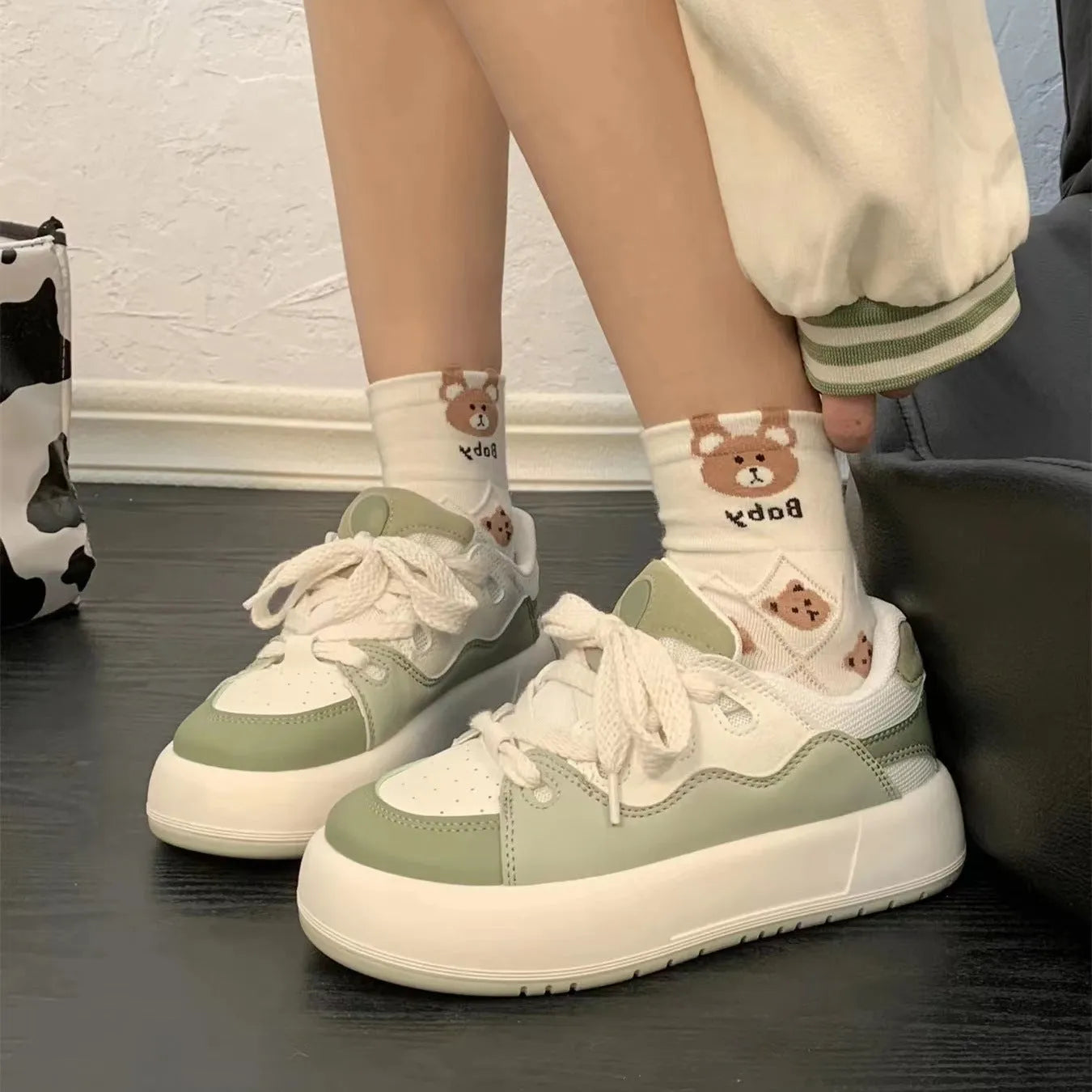 Green women's casual flat shoes with round toe and PU mesh upper on a white background.