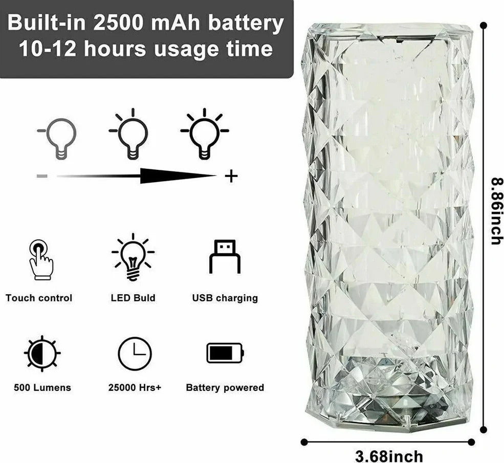 Clear acrylic LED table lamp with diamond-cut surfaces and remote control on wooden surface