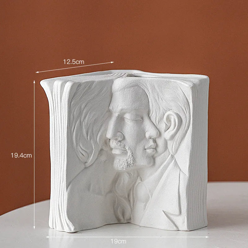 White ceramic book stand holding an open book at an angle, with a wire page holder in use.