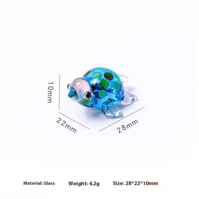 Geometric glass turtle figurine ornament on a desk, shown in blue head and blue shell colour variant.