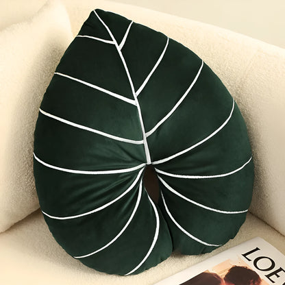 Green embroidered plant cushion with monstera leaf pattern on plush fabric