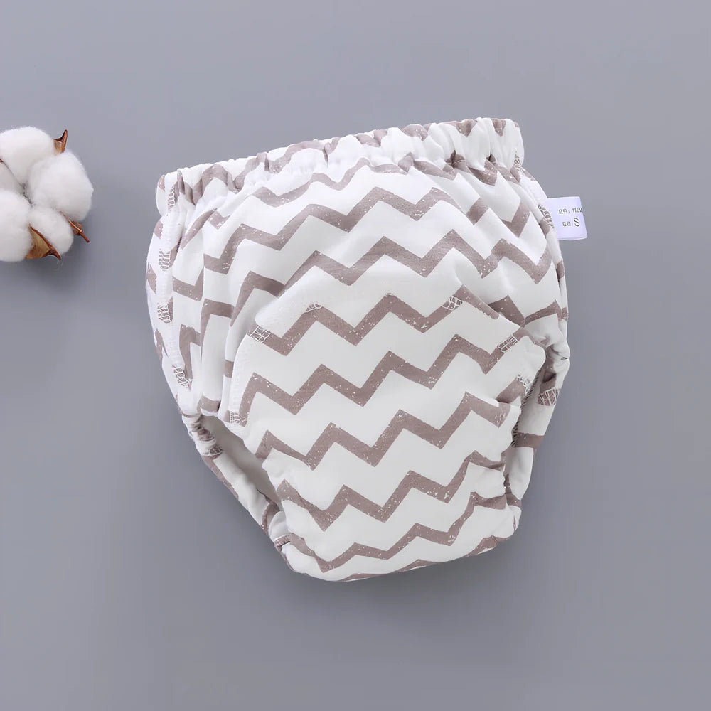 Washable baby training pants with 6-layer gauze construction in assorted patterns including animals and geometric designs