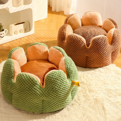 Green cactus petal shape pet bed for cats and dogs on a hardwood floor.