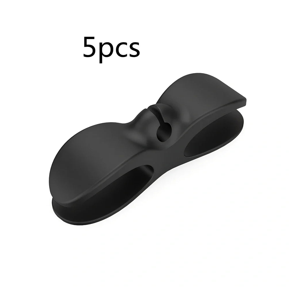 Black TPU cable organizer clips winding appliance cords on kitchen counter, 5cm size, non-marking adhesive for tidy management